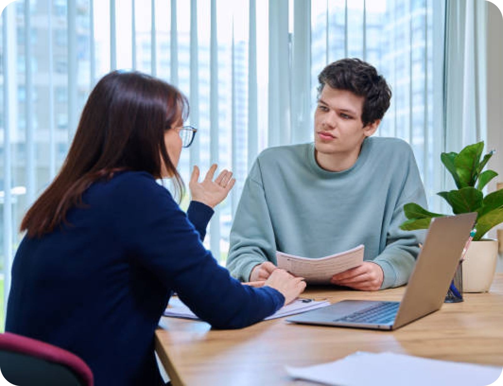 Two people discussing notes together at a table